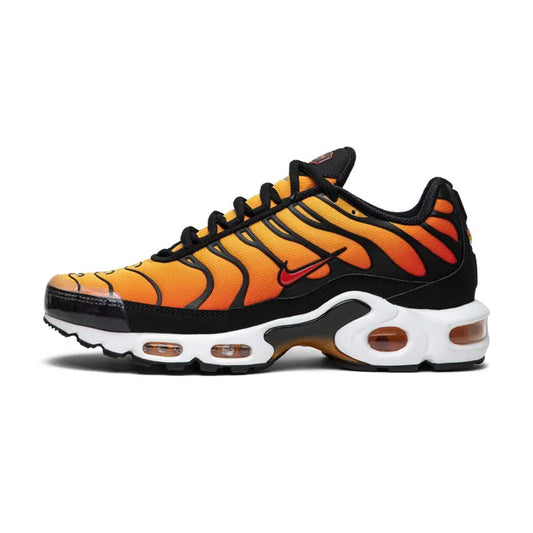Lateral profile view of the Nike Air Max Plus Sunset sneaker featuring a yellow and orange gradient mesh upper, black wavy TPU cage, mini red Swoosh, white midsole, and orange visible Tuned Air units.