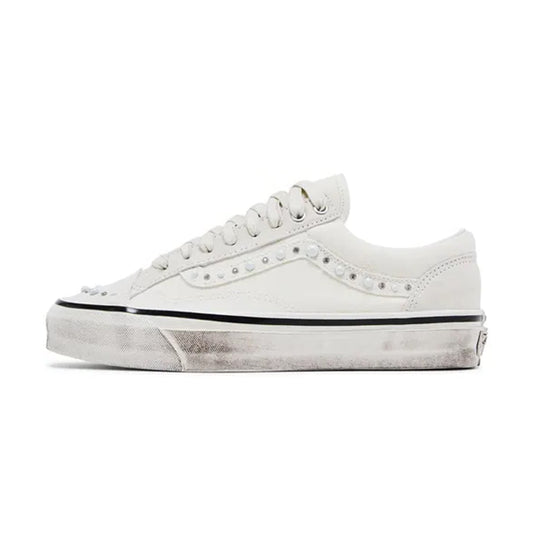 Side profile view of the Vans LX Old Skool 36 Pearlized Pack Marshmallow White sneaker featuring off-white suede and canvas, studded pearl details along the Sidestripe, toe cap, and heel counter, set on a white vulcanized sole.