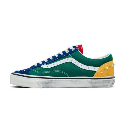 Side profile view of the Vans LX Old Skool 36 Pearlized Pack Yacht Club sneaker showcasing a green mid-panel, blue toe and eyestay, yellow heel counter, red tongue trim, white Sidestripe with pearl studs, and a distressed-look white vulcanized sole.
