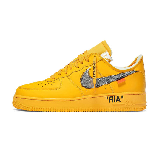 Lateral profile view of the Nike Air Force 1 Low Off-White University Gold sneaker featuring a monochromatic gold leather upper, reflective metallic silver stitched-edge Swoosh with an orange tab, black AIR text on the midsole, and an attached orange zip-tie.