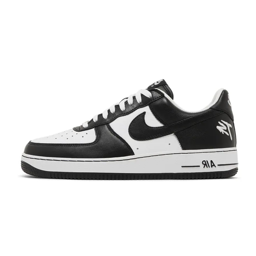 Lateral profile view of the Nike Air Force 1 Low QS Terror Squad Blackout sneaker featuring a white leather mid-panel and toe box, black leather overlays, white "TS" logo embroidery on the lateral heel, white midsole, and black rubber outsole.