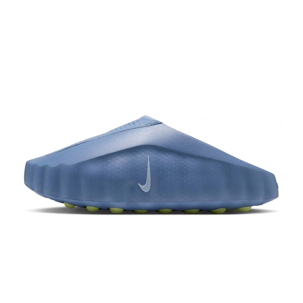 Side view of the Nike Nike Mind 001 Slide in Work Blue showing its molded foam upper, subtle silver Nike Swoosh logo, and green pod-textured outsole.