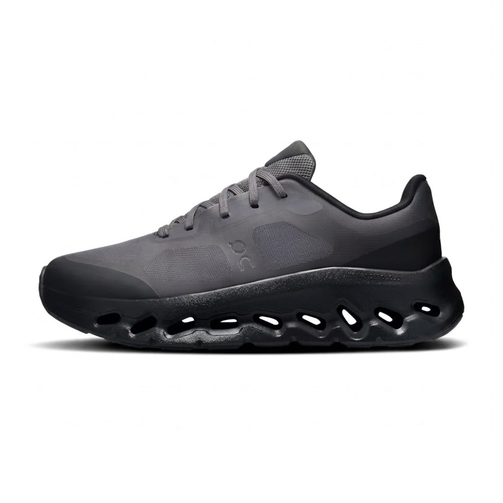 Lateral profile view of the On Running Cloudtilt Remix Black sneaker featuring a dark charcoal mesh upper, black On logo, and a fluid black CloudTec Phase midsole.
