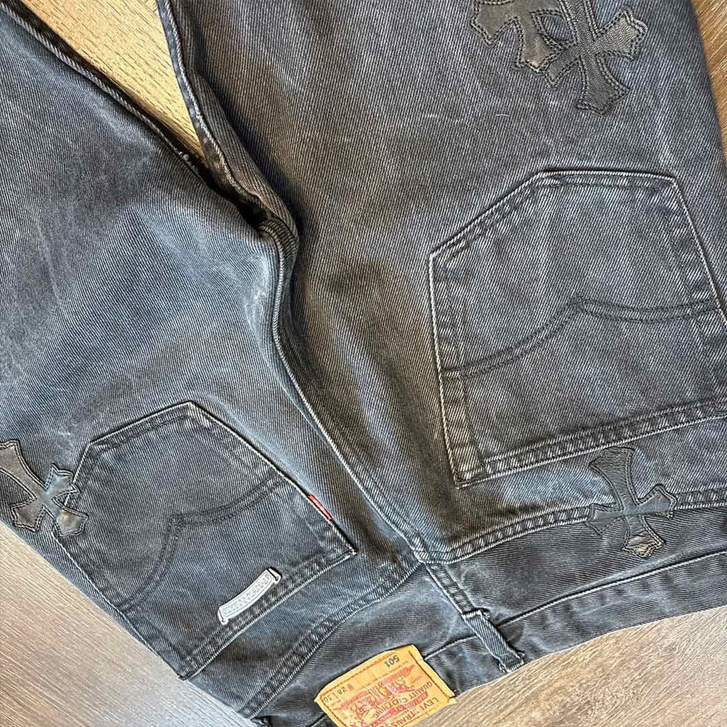 Chrome Hearts grey black denim jeans styled in luxury streetwear outfit with patch details