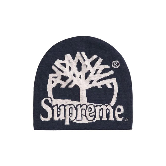 A navy blue knit beanie featuring a large white knitted Tree of Life logo and the word 'Supreme' across the front, shown on a plain white background.